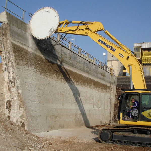 Rock tools concrete saw in action cutting into tall concrete wall