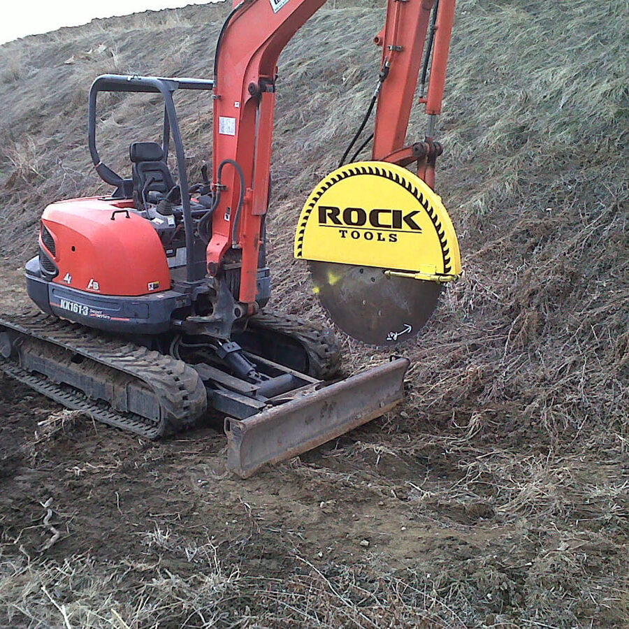 Rock tools concrete saw on tractor lifted